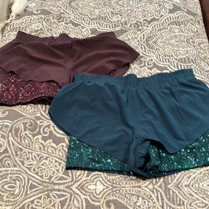 Athleta. 2 pairs of 2in1 shorts…purple and green. Great condition